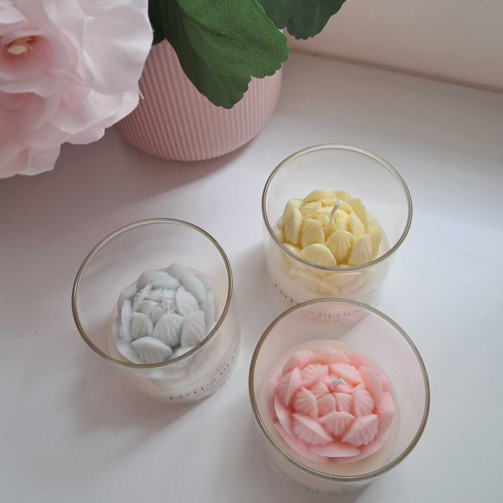 Three glass bowls with decorative flowers on a light surface