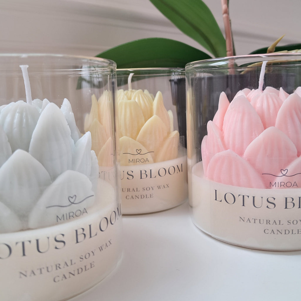 Lotus Bloom soy wax candles in glass jars with pastel lotus flower design 