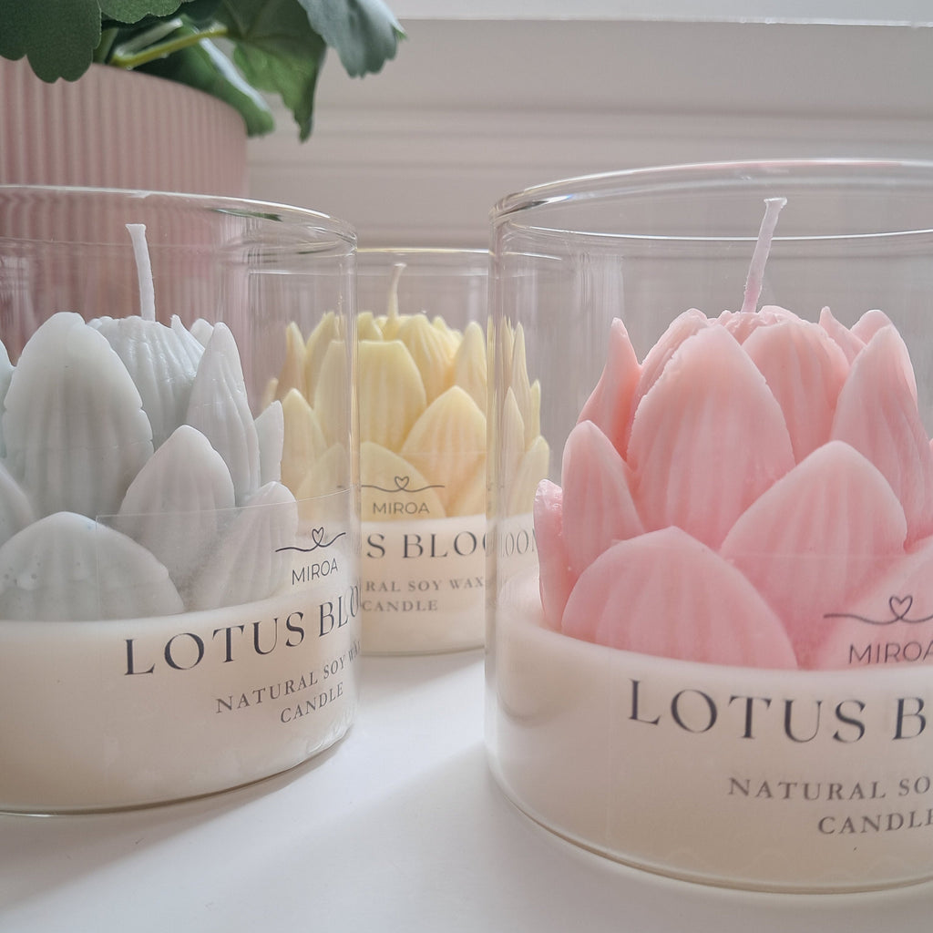 Lotus Bloom soy wax candles in glass jars with pastel lotus flower design